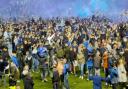 Fans run on to the pitch after Portsmouth gain promotion.