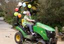 Trish Brenchley driving her balloon-bedecked tractor