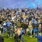 Fans run on to the pitch after Portsmouth gain promotion.