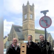 From left, Rev Brian Harley, Bob Lord, Robin Harley in front of Shanklin United Reform Church' s bell tower