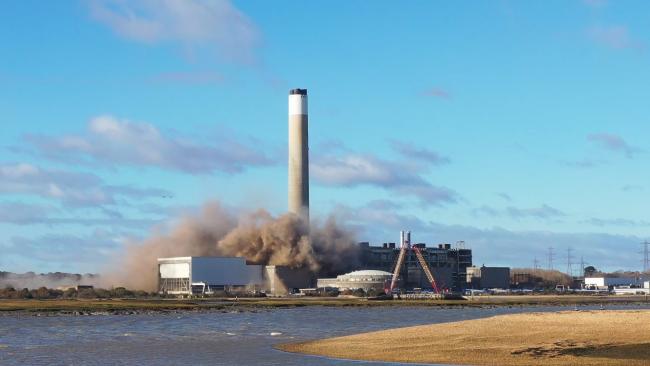 Part of Fawley power station comes crashing down in a controlled explosion. Picture by Neil Mockridge.