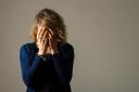 EMBARGOED TO 0001 FRIDAY NOVEMBER 17 PICTURE POSED BY A MODEL File photo dated 09/03/15 of a woman with her hands covering her face. Women should be offered talking therapy on the NHS to combat the symptoms of menopause, according to new guidance. Issue