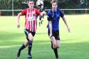 Cory Sanderson, left, in action for East Cowes Vics against Clanfield on Saturday.