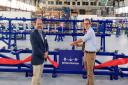 MP Bob Seely, right, cuts the ribbon on the production line at Britten-Norman in Bembridge while