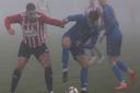 Dead-ball specialist Harry Taylor in a midfield battle at a foggy Beatrice Avenue on Saturday