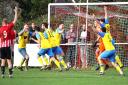 Newport (in yellow) celebrate their third goal against East Cowes Vics on Boxing Day.