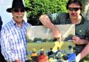 Keith Mitchell, left, with former England and Gloucestershire wicketkeeper turned artist, Jack Russell, pointing him out as a spectator in one of his paintings at a match in Sussex.
