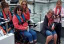 Disabled people enjoying a previous outing with Cowes Sailability Club.