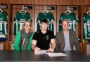 Rugby star Rory Taylor signing his contract. Picture by London Irish.