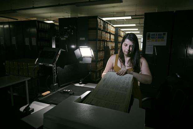 Isle of Wight County Press: Laura Gowing, a Findmypast technician, scanning individual pages of the 30,000 volumes of the 1921 census (Mikael Buck/Findmypast/PA)