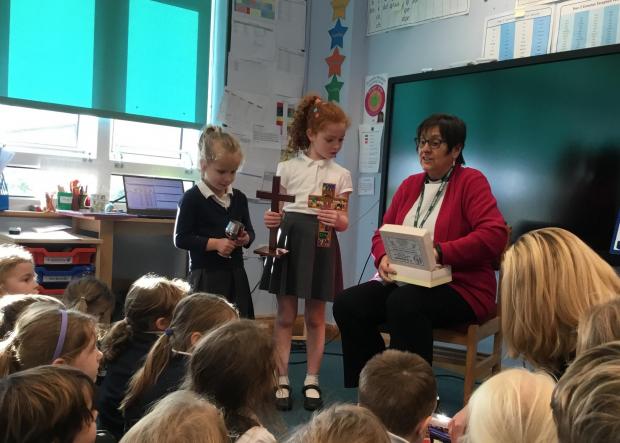 Isle of Wight County Press: Reverend Jackie Maw with school children, Brighstone Primary School.