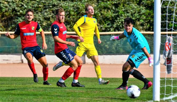 Isle of Wight County Press: Connor Kelly (in yellow) scored one and made one for Newport at Ash United. Photo: Graham Brown