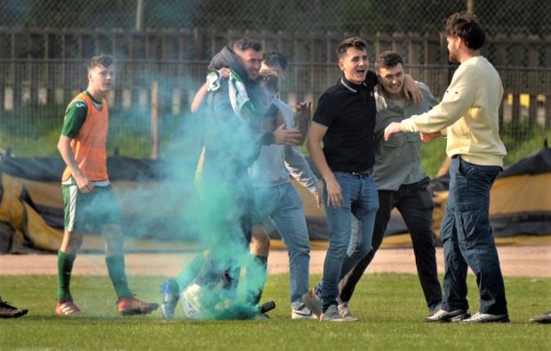 Isle of Wight County Press: Laverstock and Ford fans set off a flare on the Smallbrook pitch at full time. Photo: Simon Dear