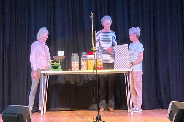 Valerie Rezin as the shop assistant, Janet Haire and Sian Rustell as customers in Sherbet Lemons and Bon Bons by Curtain Up.