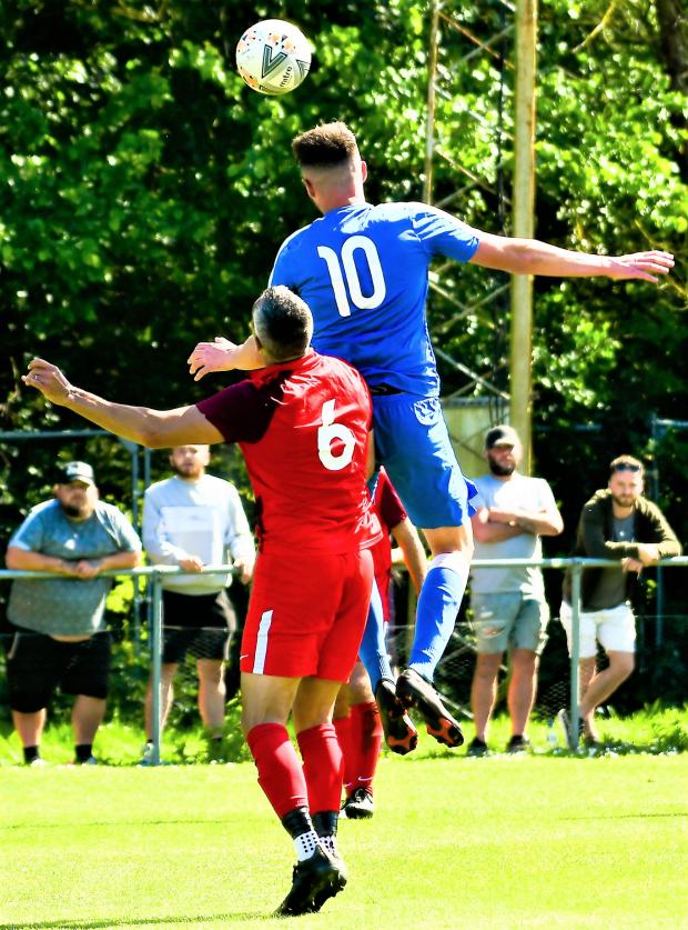 Isle of Wight County Press: Kyle Drew wins a header against Brading's Dean Stuber. 