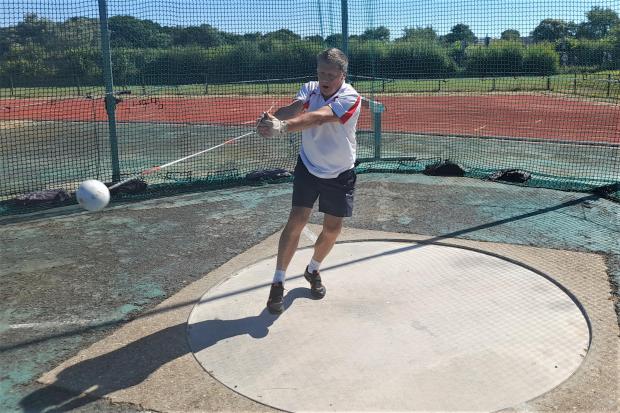 Isle of Wight County Press: Veteran hammer thrower, Stephen Duff, marks the occasion with the first hammer thrown at the newly named track. Photo: Jon Moreno