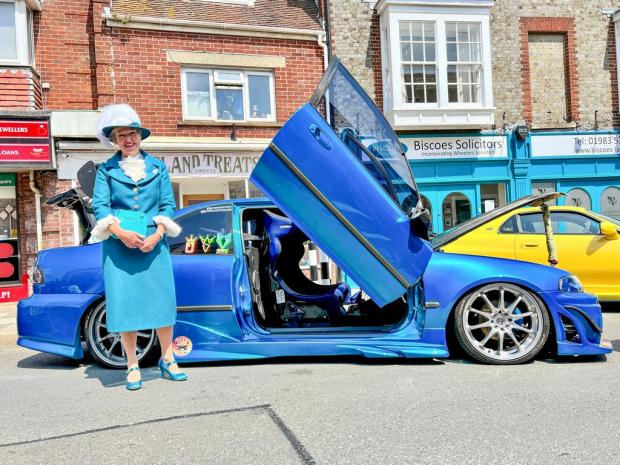 Isle of Wight County Press: High Sheriff Kay Marriott with a car on display in Newport. Photo: Pamela Parker.