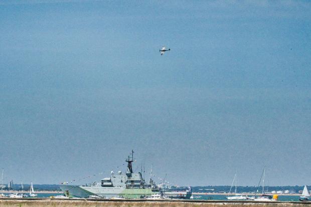 Isle of Wight County Press: Spitfire over HMS Severn. Picture by Ricky Ashanollah.