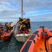 Cowes lifeboat stands off as crew members of both Cowes and Calshot lifeboats go aboard the 40-foot yacht on Saturday, to provide assistance.