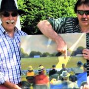 Keith Mitchell, left, with former England and Gloucestershire wicketkeeper turned artist, Jack Russell, pointing him out as a spectator in one of his paintings at a match in Sussex.