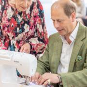 Margaret Loveridge, who attends Creative Café and has made miles of Jubilee bunting, teaches His Royal Highness how it is sewn.