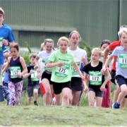 Youngsters sprint off in the junior Duver Dash to mark the beginning of this year's Isle of Wight Festival of Running.