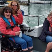 Disabled people enjoying a previous outing with Cowes Sailability Club.