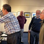 The Isle of Wight Photographic Society exhibition being hung.