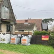 The Wootton Against Gravel Extraction (WAGE) sign and bags of ballast.