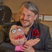 Richard Herring holding a puppet.