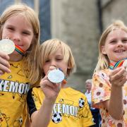 Thomas, Sam and Tilly who loved the medals, won at the Team Isle of Wight Island Games fun day, in Newport.