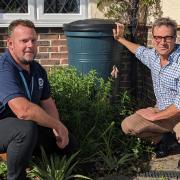 From left: Ian Deakin, Southern Water and Bob Seely MP with one of Southern Water's slow-drain water butts.