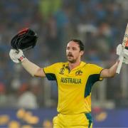 Travis Head raises his bat as he celebrates his century in the World Cup final