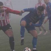 Dead-ball specialist Harry Taylor in a midfield battle at a foggy Beatrice Avenue on Saturday