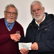 Ron Wallis of the IW VMCC presenting a cheque to Roger Dennis of the IW Prostate Cancer Support Group