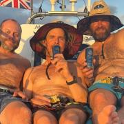 The Mermaid Atlantic crew of Chris Mannion, Paul Berry and Xavier Baker celebrating reaching half-way across the Atlantic with a gin and tonic.