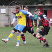 Macauley Waterson holds off a Romsey forward