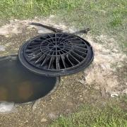 A drain blocked by sewage close to a children's play park on the Island.