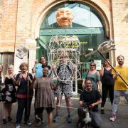 Andrew Kim of Thingumigig Theatre and New Carnival creative volunteers with the giant Green Man puppet structure