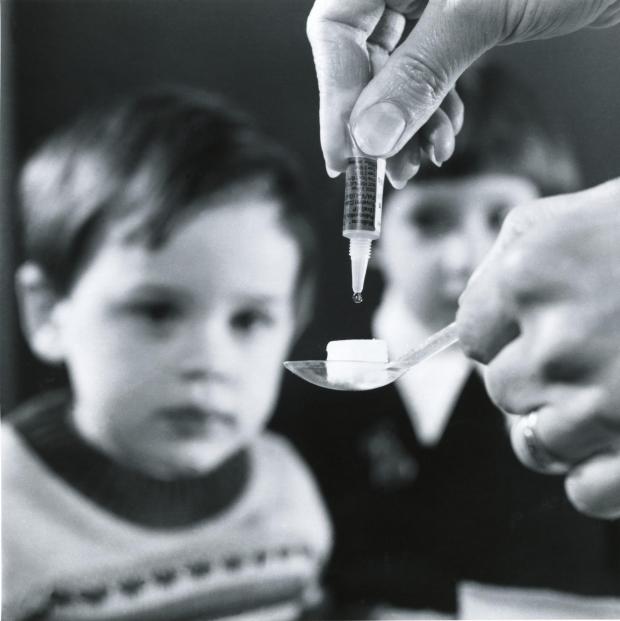 Isle of Wight County Press: Polio vaccine dropped onto a sugar lump for child patient. Picture by Wellcome Images.