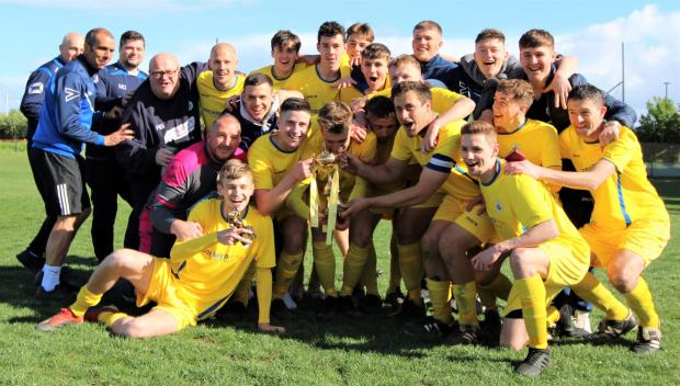Isle of Wight County Press: Newport celebrating winning the Isle of Wight (Senior) Gold Cup in 2019 — the last time the final was played. Photo: Graham Brown